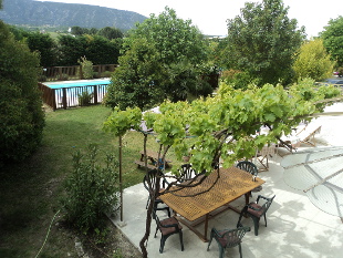 Provence bike trips - Room Ménerbes - View over the pool and garden to the Luberon hills.